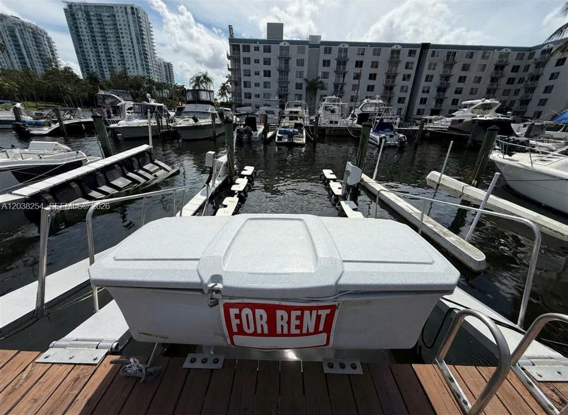 A boat slip with a storage box labeled for rent overlooks a marina and buildings — 1700 NW North River Dr, Miami FL 33125, MIAMI, FL