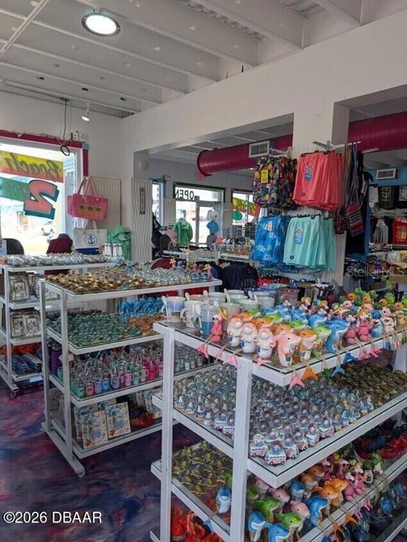 A retail store interior features multiple shelves stocked with various souvenirs, gifts, and apparel — 128 S ATLANTIC AVENUE, DAYTONA BEACH, FL