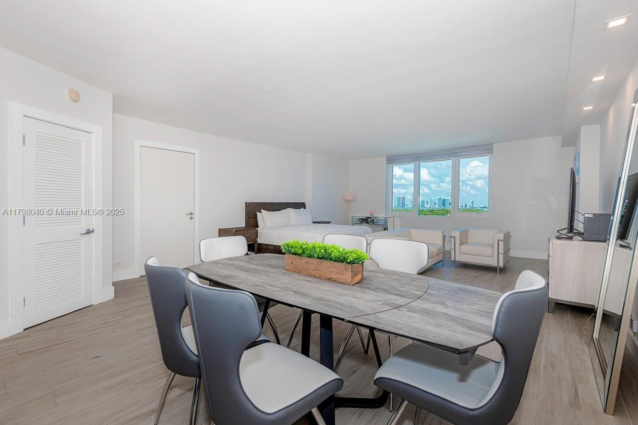 A modern studio apartment features a dining area, a bed, and floor-to-ceiling windows — 2301 Collins Ave # 1531, Miami Beach FL 33139, MIAMI BEACH, FL