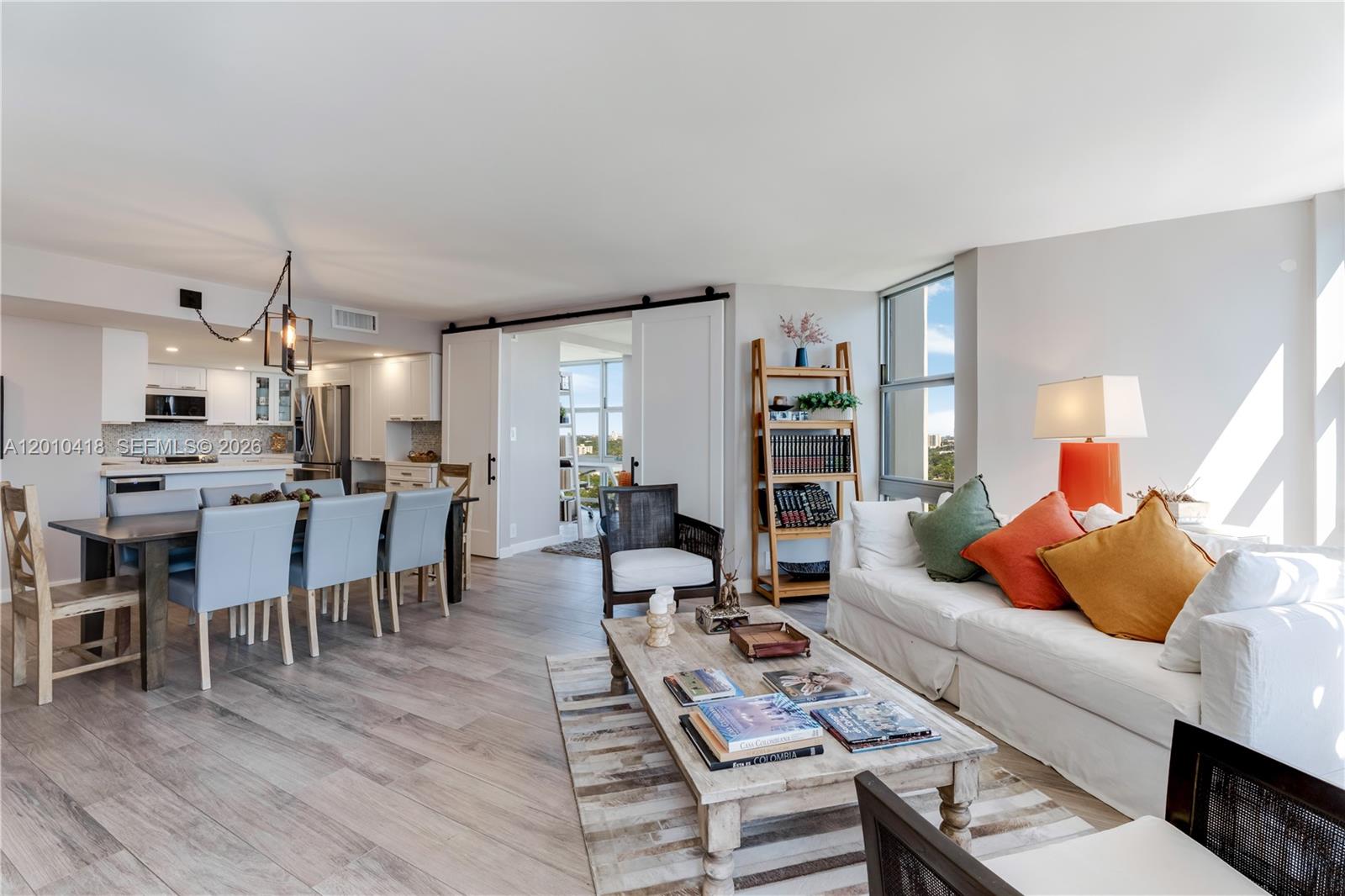 A modern kitchen features white cabinetry, stainless steel appliances, and a mosaic tile backsplash — 1901 Brickell Ave # B1809, Miami FL 33129, MIAMI, FL