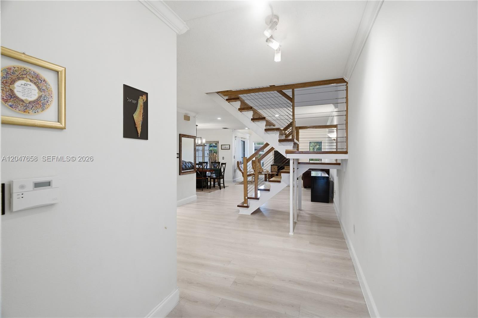 An interior view shows a staircase with wooden treads and metal railings in a home — 2822 N 34th Ave, Hollywood FL 33021, HOLLYWOOD, FL