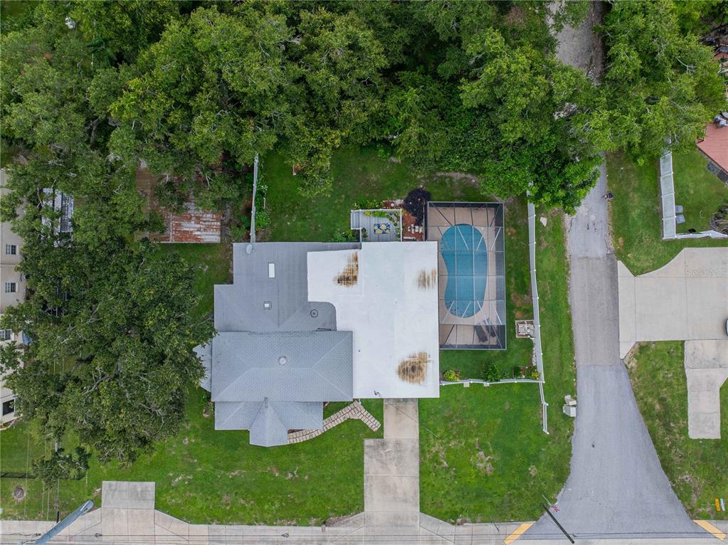 An aerial view shows a house with a pool, screened enclosure, and surrounding yard — 5140 LAKELAND HIGHLANDS ROAD, LAKELAND, FL