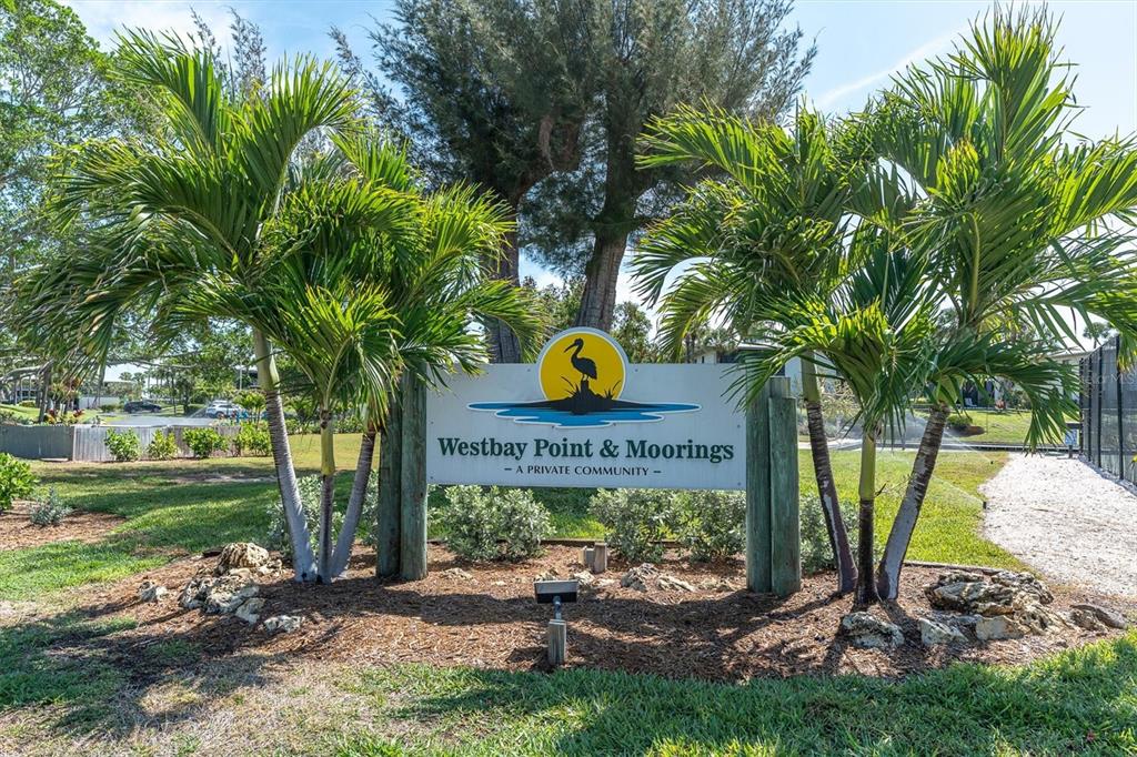 A sign for Westbay Point & Moorings stands between two palm trees in a grassy area — 6500 FLOTILLA DRIVE UNIT 187, HOLMES BEACH, FL