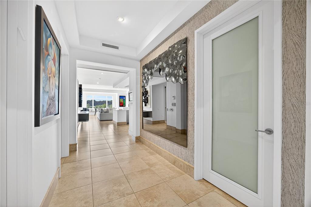 A hallway with tile floors, a large decorative mirror, and a frosted glass door — . COND PLANTATION VILLAGE STREET UNIT 3-303, DORADO, PR