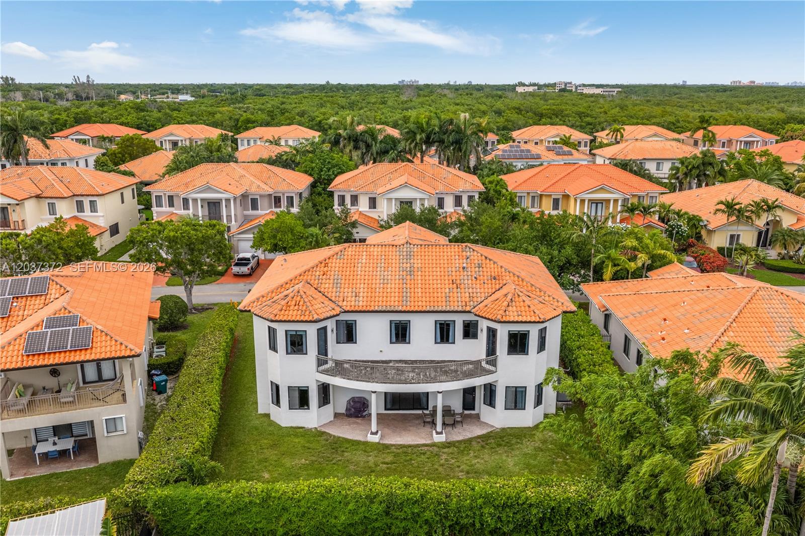 An aerial view shows the rear exterior of a two-story house with a tiled roof — 7504 SW 188th Ter, Cutler Bay FL 33157, CUTLER BAY, FL