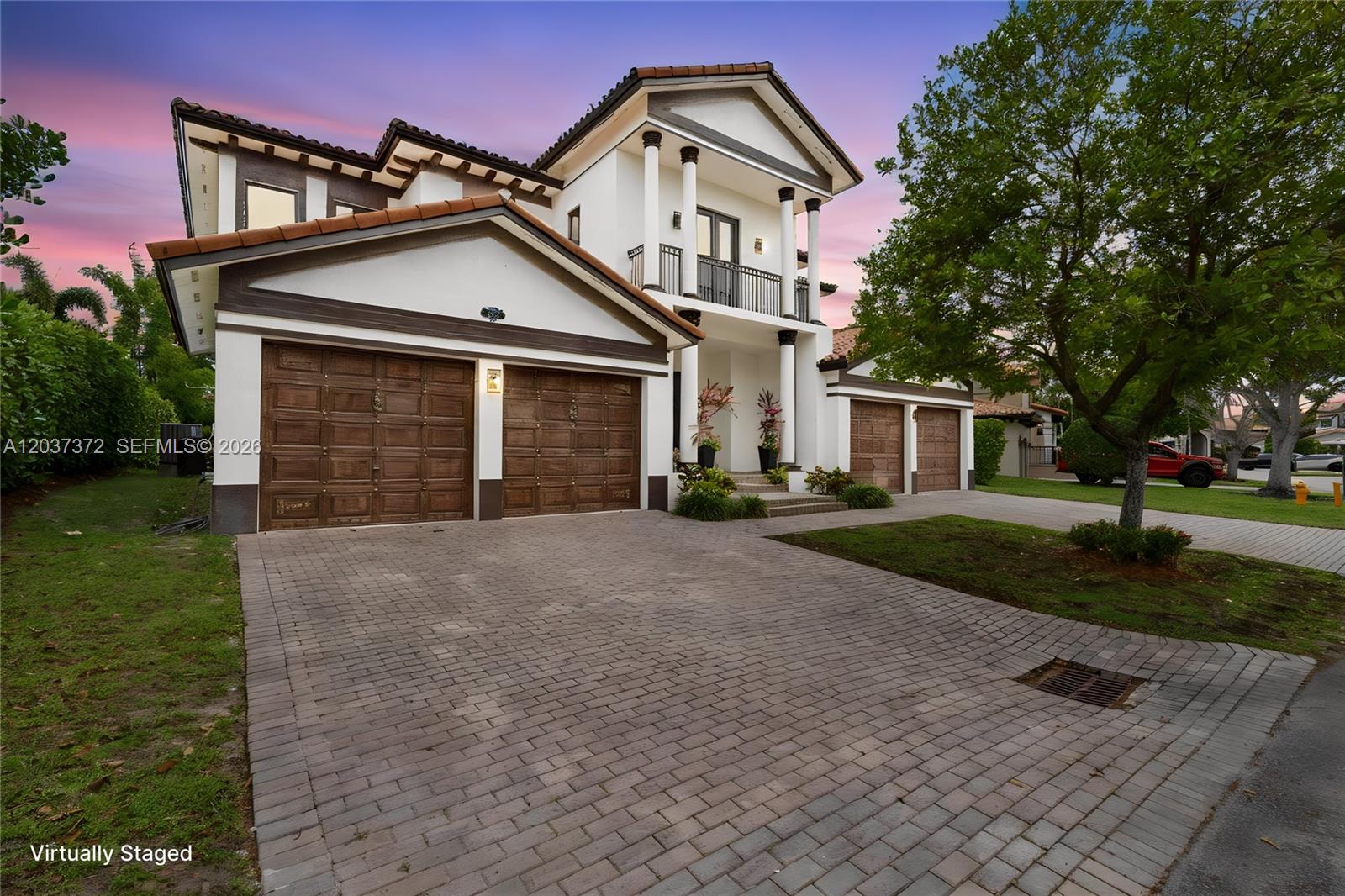 A two-story house with a three-car garage, white stucco walls, and a paved driveway — 7504 SW 188th Ter, Cutler Bay FL 33157, CUTLER BAY, FL