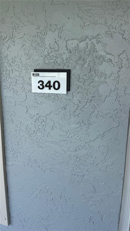 A close-up view of a room number sign reading 340 on a textured gray wall — 122 WATER FRONT WAY UNIT 340, ALTAMONTE SPRINGS, FL