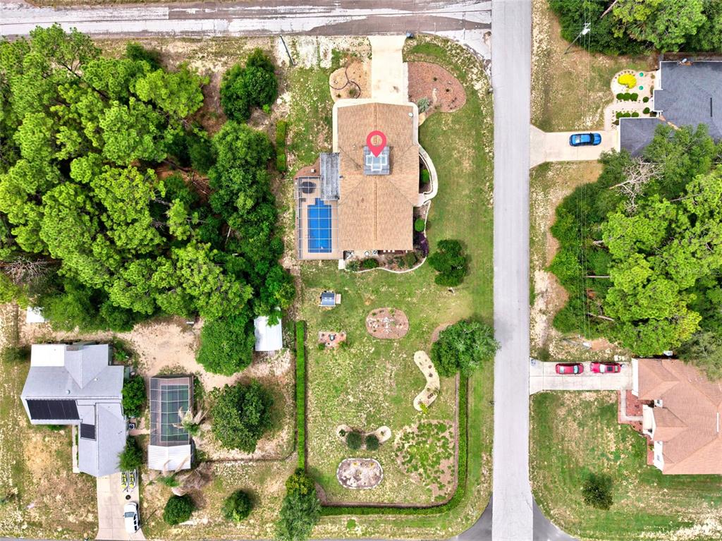 An aerial view shows a house with a pool and a large yard — 10848 N DRAGONIS DRIVE, DUNNELLON, FL