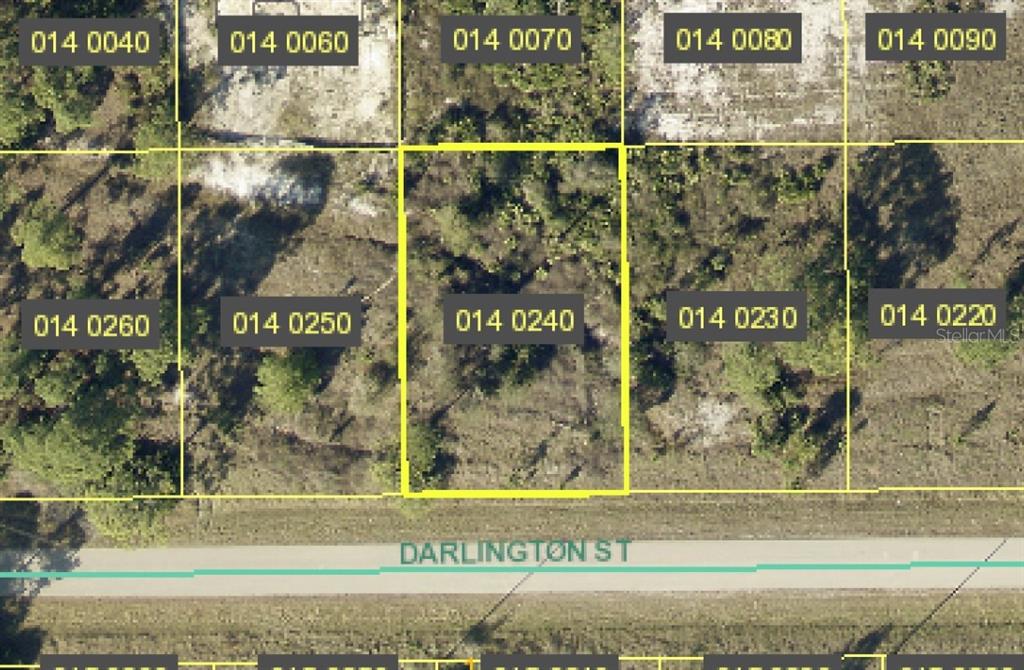 This is an aerial map showing a vacant lot highlighted in yellow along Darlington Street — 1035 DARLINGTON STREET, LEHIGH ACRES, FL