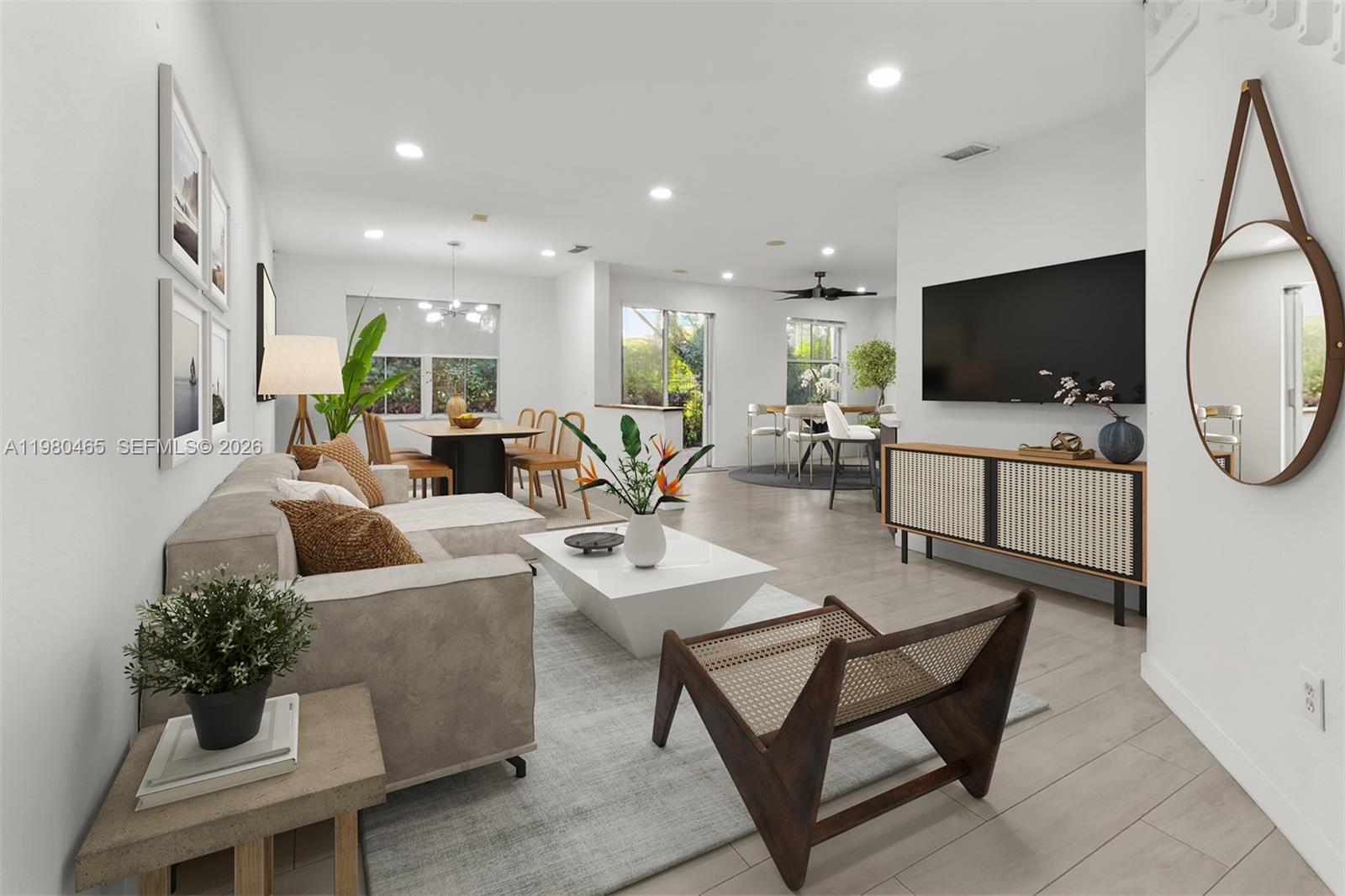A bright, open-concept living and dining area features light wood flooring and modern neutral decor — 17130 SW 36th Ct, Miramar FL 33027, MIRAMAR, FL