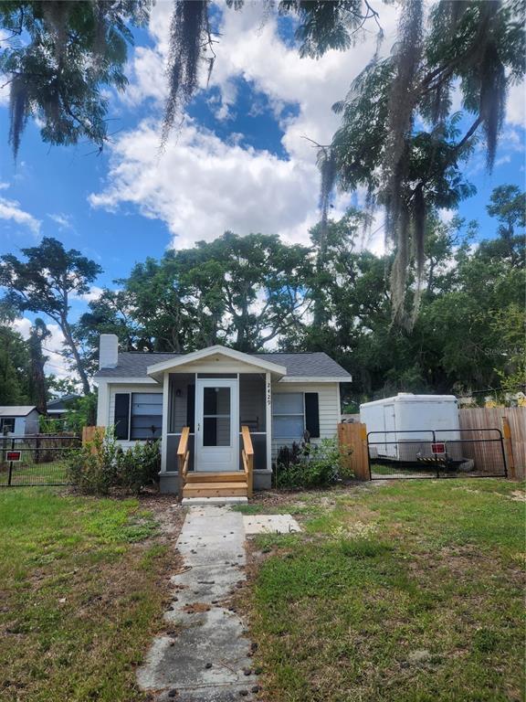 A small, light-colored house with a front porch and a trailer parked in the yard — 2429 LAKEVIEW STREET, LAKELAND, FL