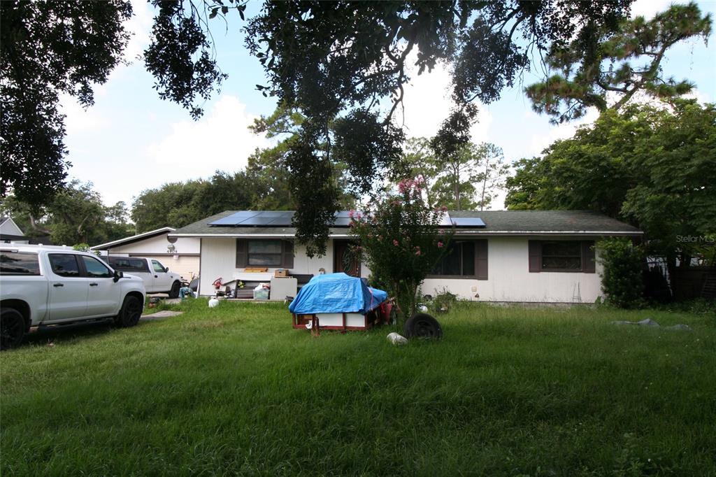 A single-story house with solar panels on the roof and a white truck parked outside — 4904 TINKHAM AVENUE, ORLANDO, FL