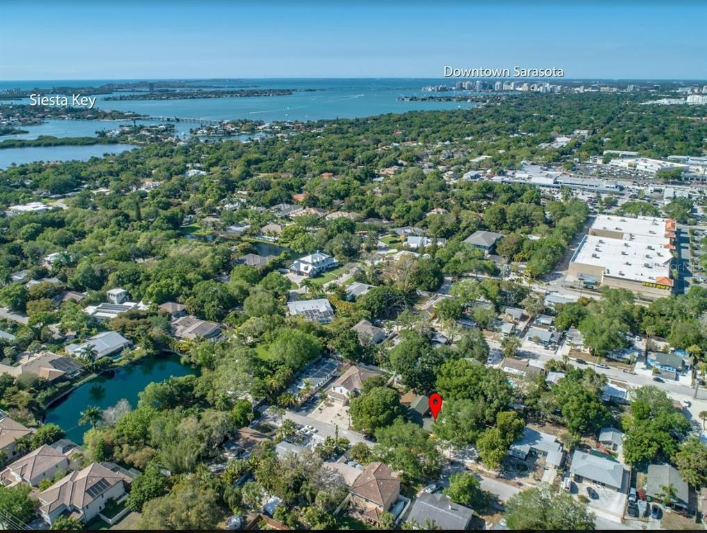An aerial view shows a residential neighborhood with a red pin marking a specific house — 1817 IVANHOE STREET UNIT A&B, SARASOTA, FL