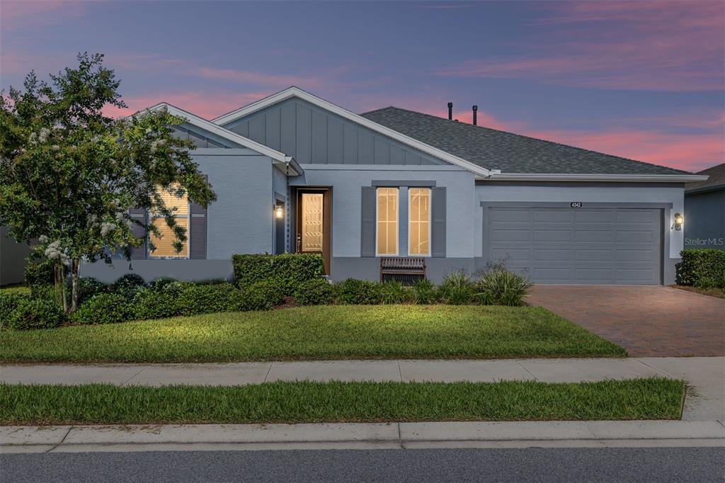 A single-story house with a gray exterior, a two-car garage, and a landscaped front yard — 4342 NW 55TH COURT, OCALA, FL