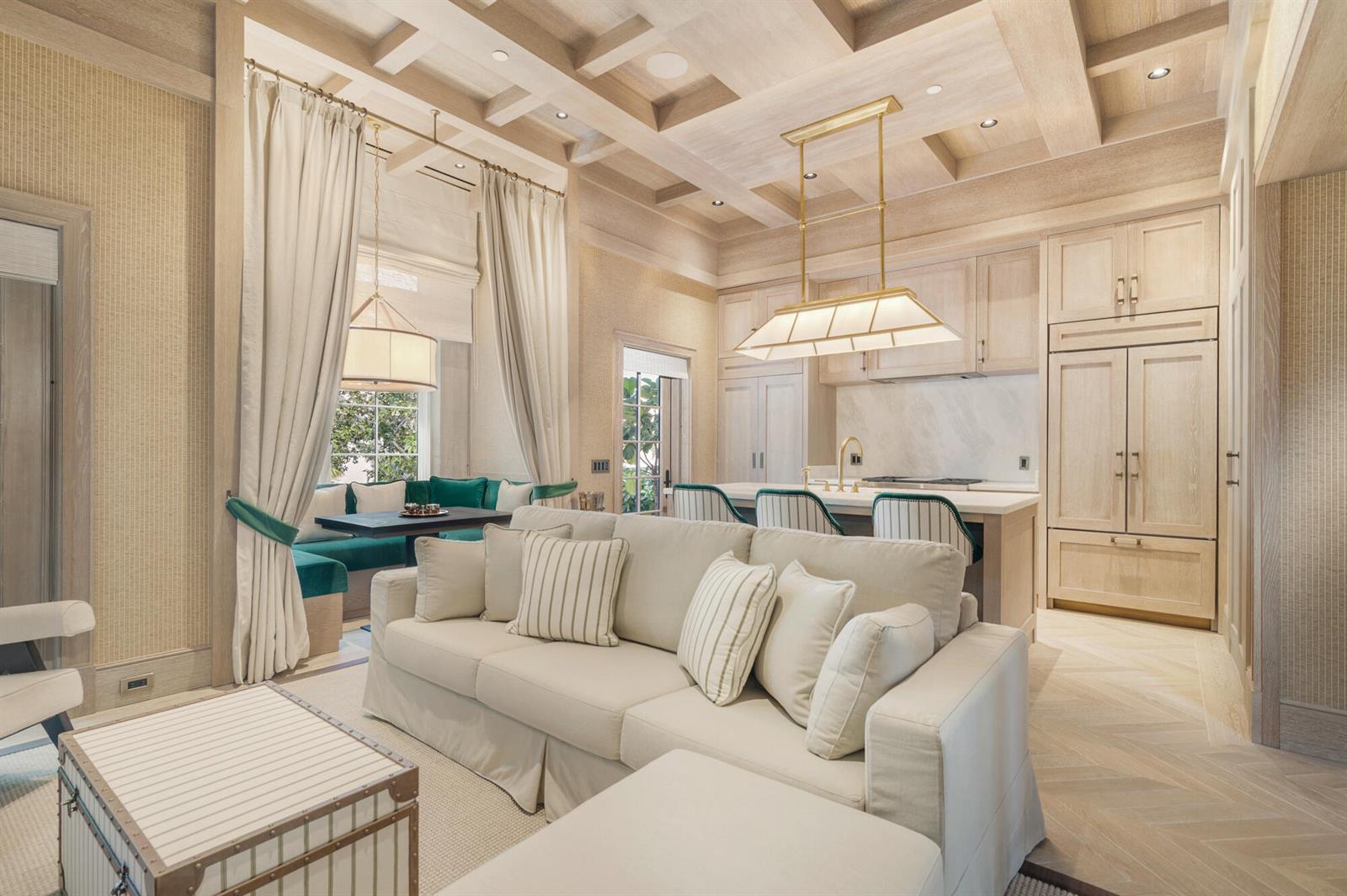 A living room and kitchen area featuring light wood cabinetry, a coffered ceiling, and herringbone floors — 236 Phipps Plaza # 201, Palm Beach FL 33480, PALM BEACH, FL