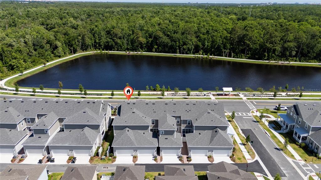 An aerial view shows a row of townhouses situated next to a large pond — 2402 CELEBRATION BOULEVARD, KISSIMMEE, FL