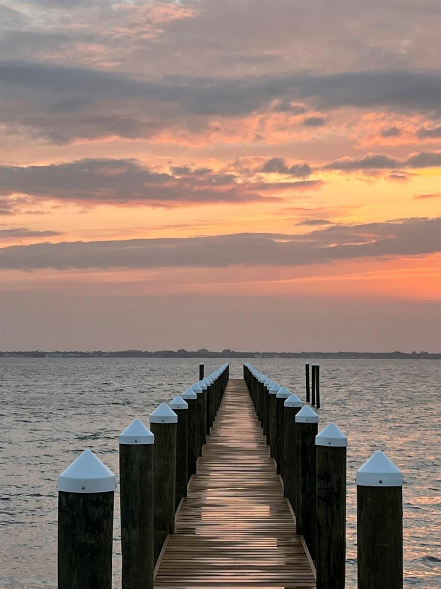 A wooden pier extends into the water under a colorful sunset sky — 12880 Highway A1a, Vero Beach FL 32963, VERO BEACH, FL