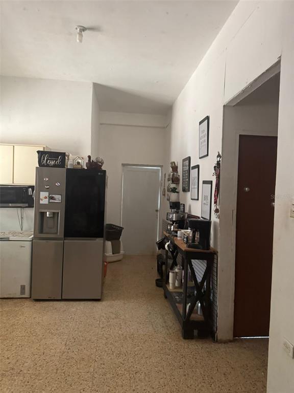 A kitchen area features a refrigerator, a coffee station, and a doorway leading outside — calle 1 CALLE 1 UNIT A 10, TRUJILLO ALTO, PR