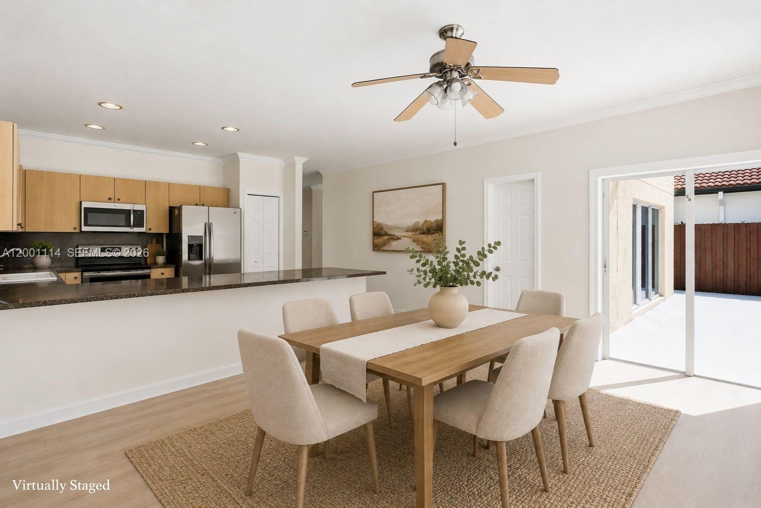 This dining area features a wooden table, six chairs, and an adjacent kitchen with countertops — 13474 SW 124th Ave Rd, Miami FL 33186, MIAMI, FL