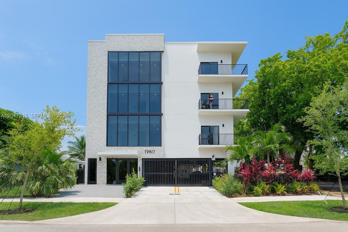 A modern three-story building with a white facade, glass windows, and black metal balconies — 1950 Fletcher St # 305, Hollywood FL 33020, HOLLYWOOD, FL
