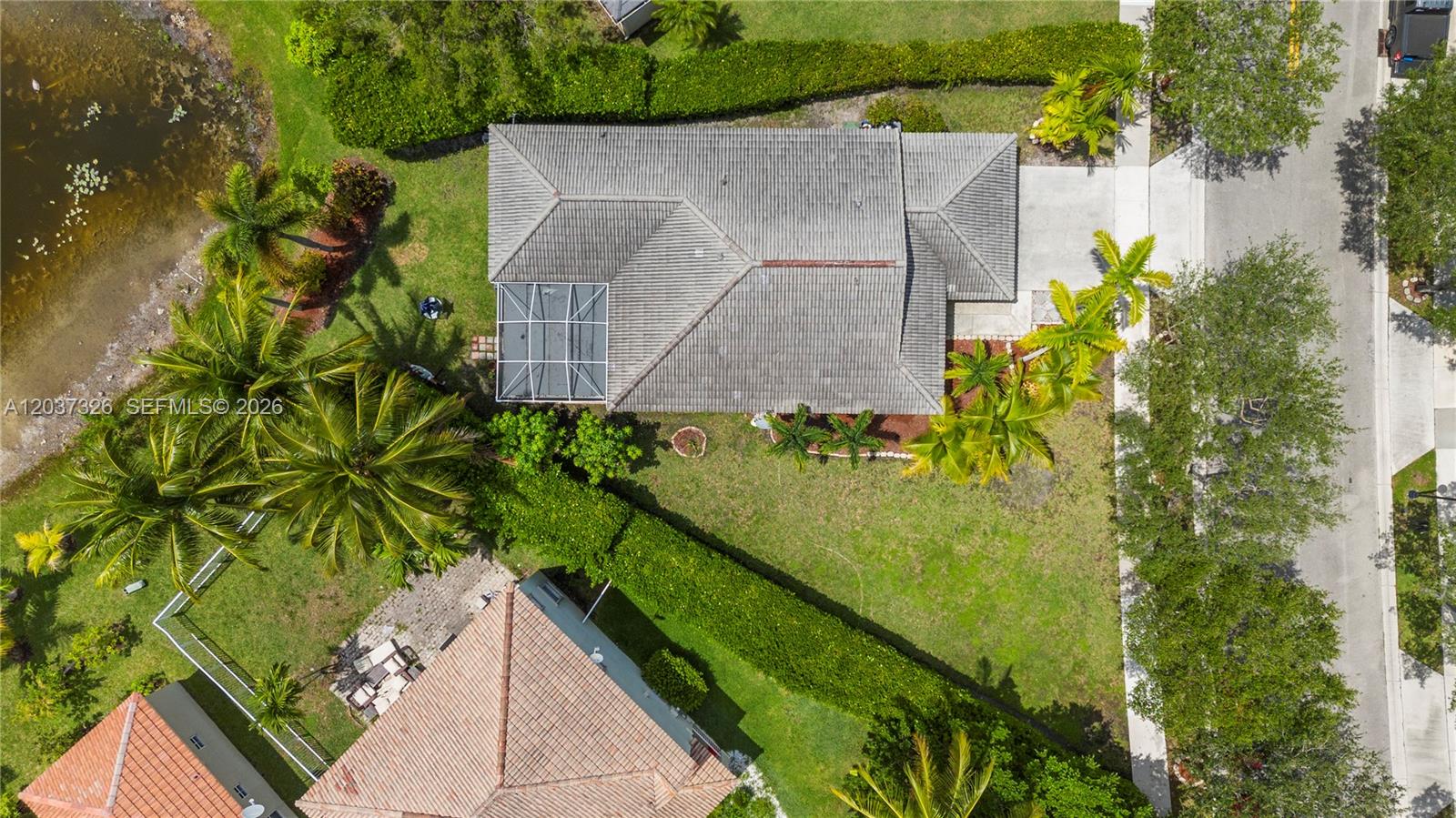 An aerial view shows a house with a screened patio, pool, and surrounding landscaping — 649 Willow Bend Rd, Weston FL 33327, WESTON, FL
