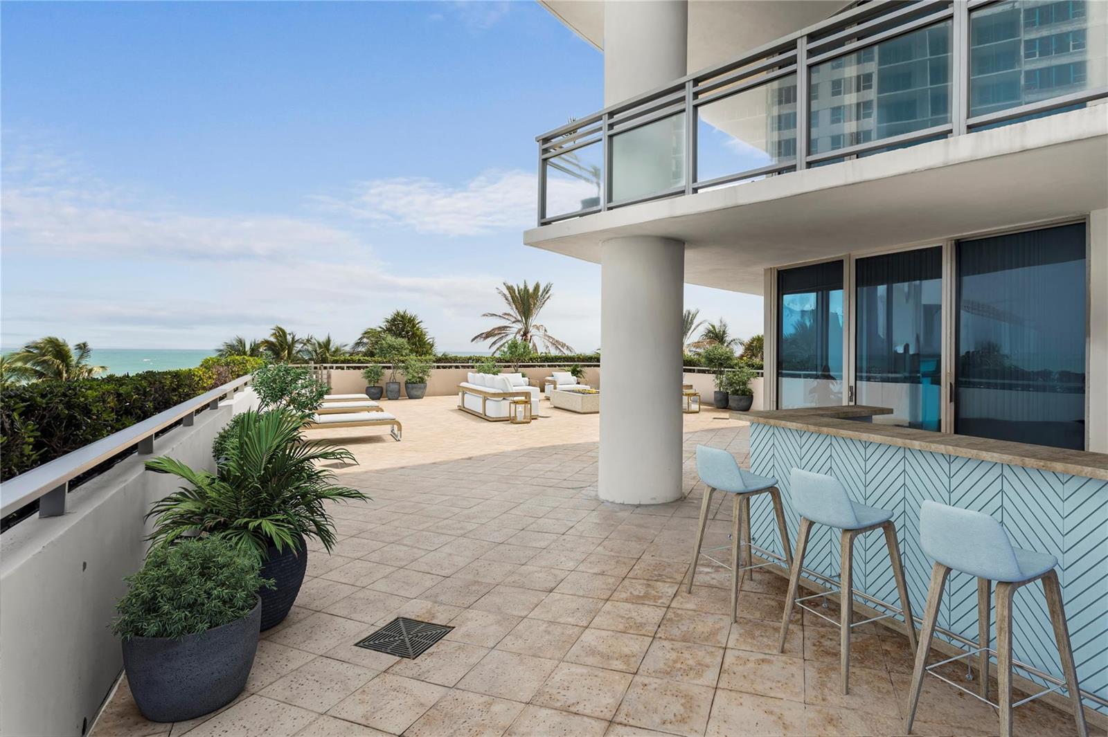 A spacious outdoor terrace features a bar with light blue stools and ocean views — 3535 S Ocean Drive # 402, Hollywood FL 33019, HOLLYWOOD, FL
