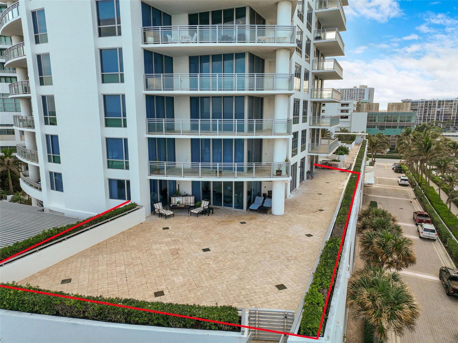 An aerial view of a large, tiled outdoor terrace with a hedge border at a building — 3535 S Ocean Drive # 402, Hollywood FL 33019, HOLLYWOOD, FL