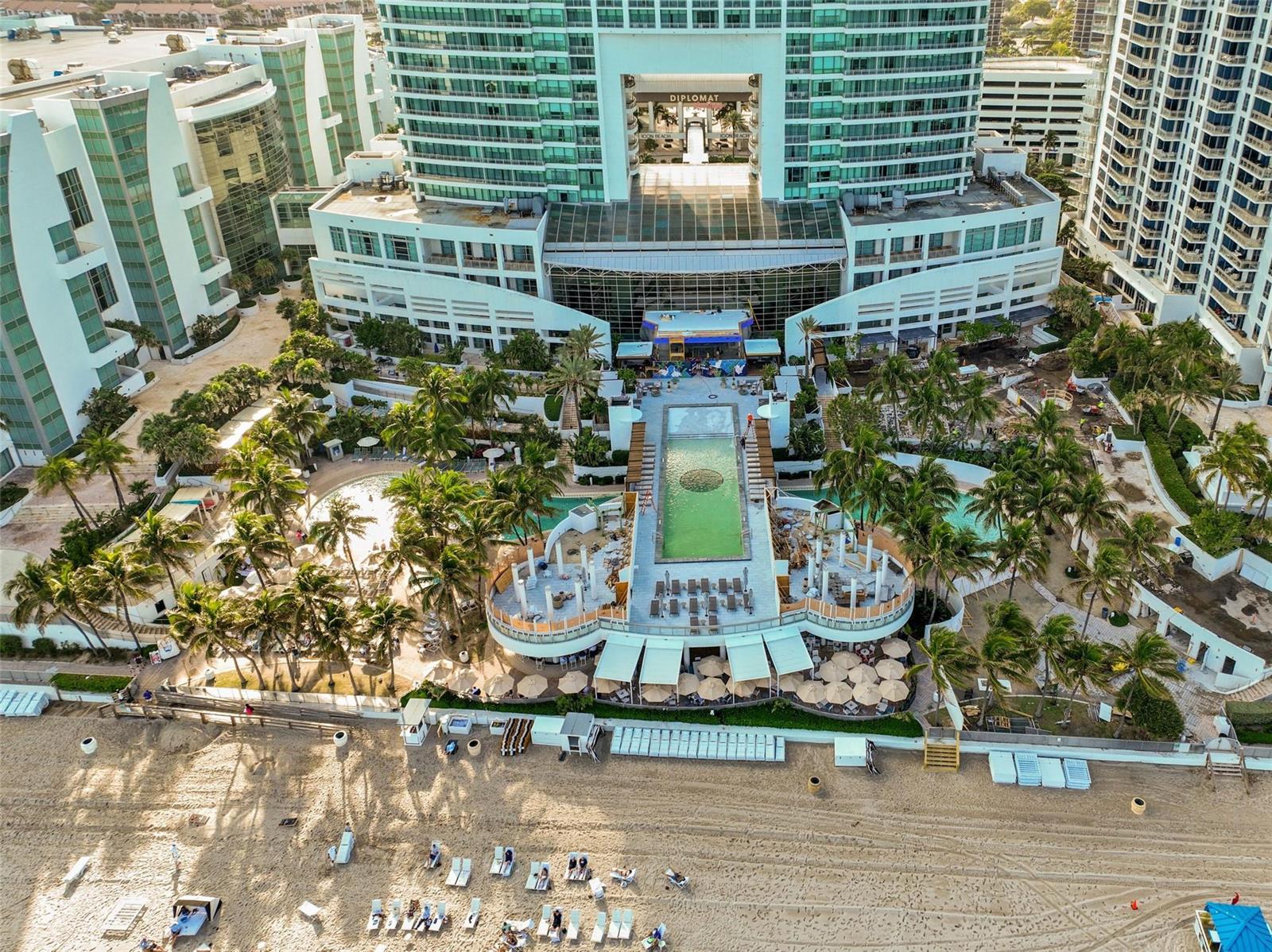 An aerial view of a beachfront hotel with a large pool deck and palm trees — 3535 S Ocean Drive # 402, Hollywood FL 33019, HOLLYWOOD, FL