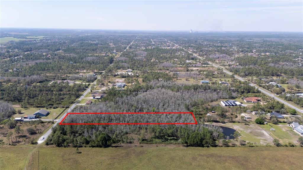An aerial view shows a rectangular plot of wooded land outlined in red — SABAL STREET, ORLANDO, FL