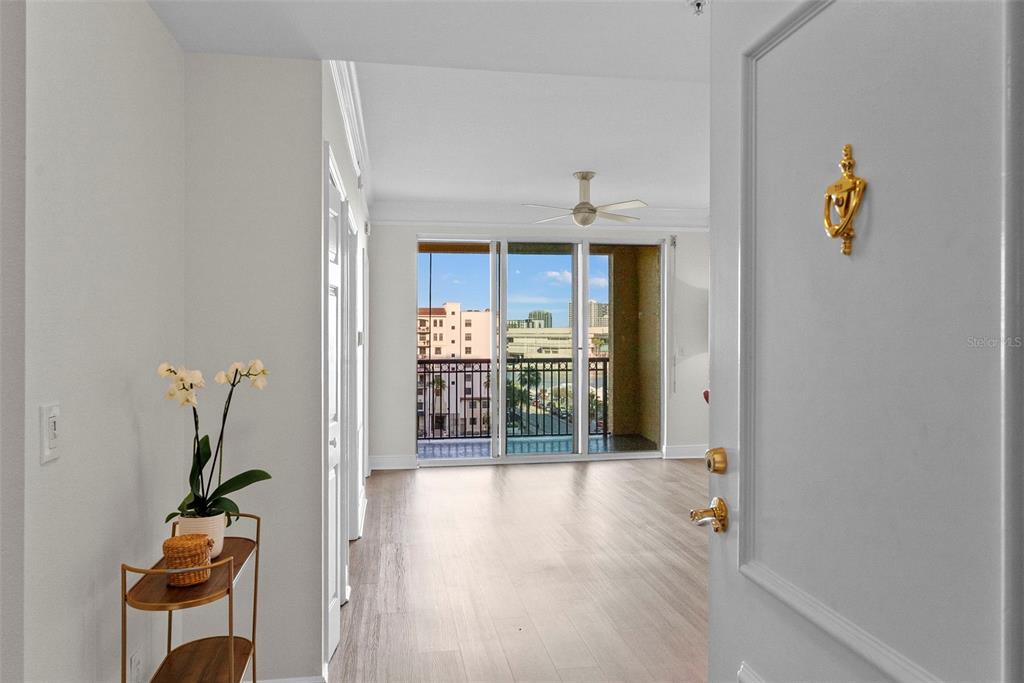 A view from an open doorway into a bright living area with wood-look flooring — 345 BAYSHORE BOULEVARD UNIT 710, TAMPA, FL