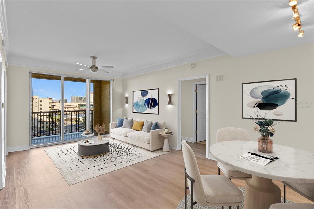 A living and dining area with light wood floors, a balcony, and modern neutral furniture — 345 BAYSHORE BOULEVARD UNIT 710, TAMPA, FL