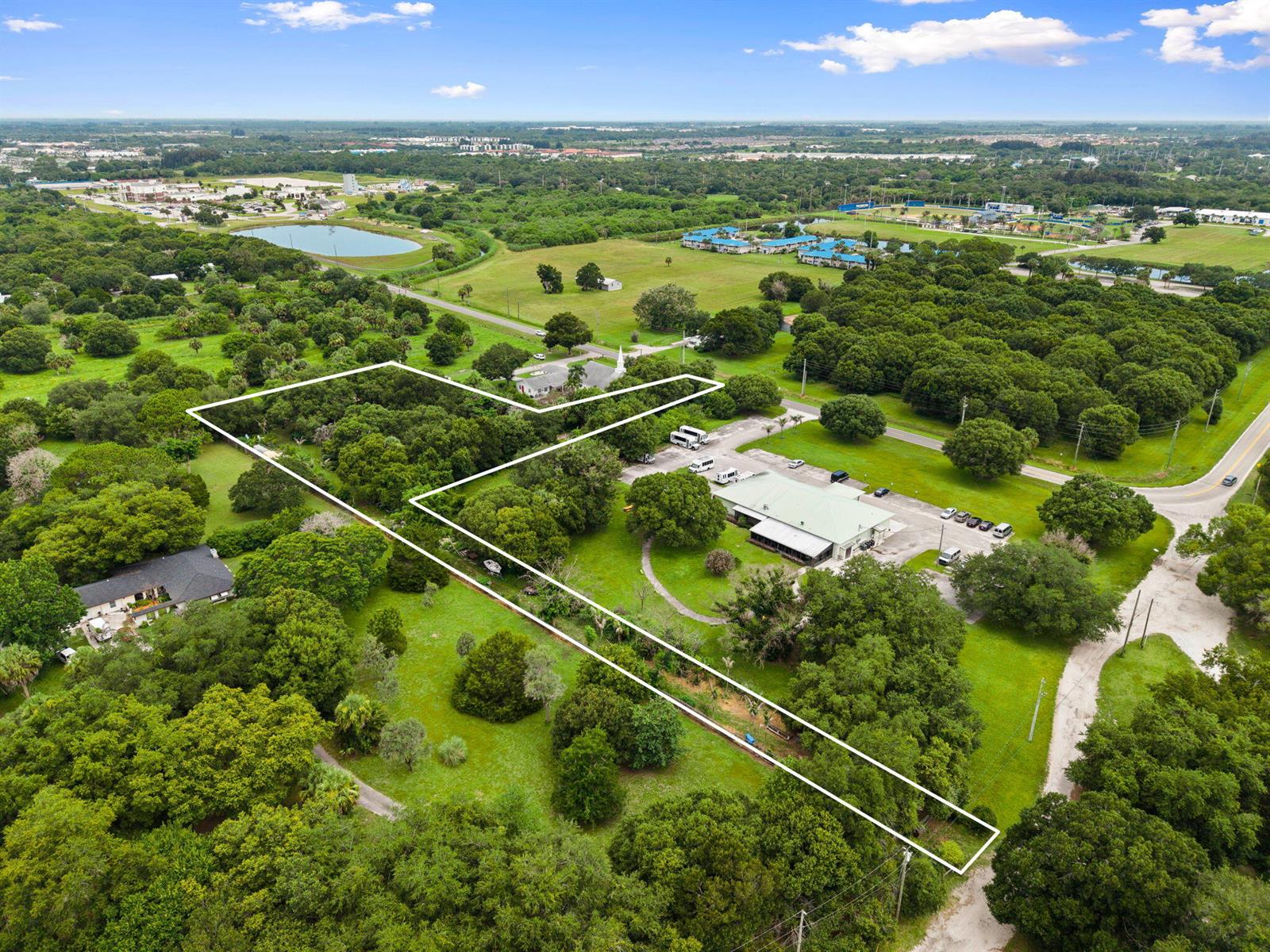 An aerial view shows a large, wooded plot of land outlined in white — 3603 Kirby Loop Road, Fort Pierce FL 34981, FORT PIERCE, FL