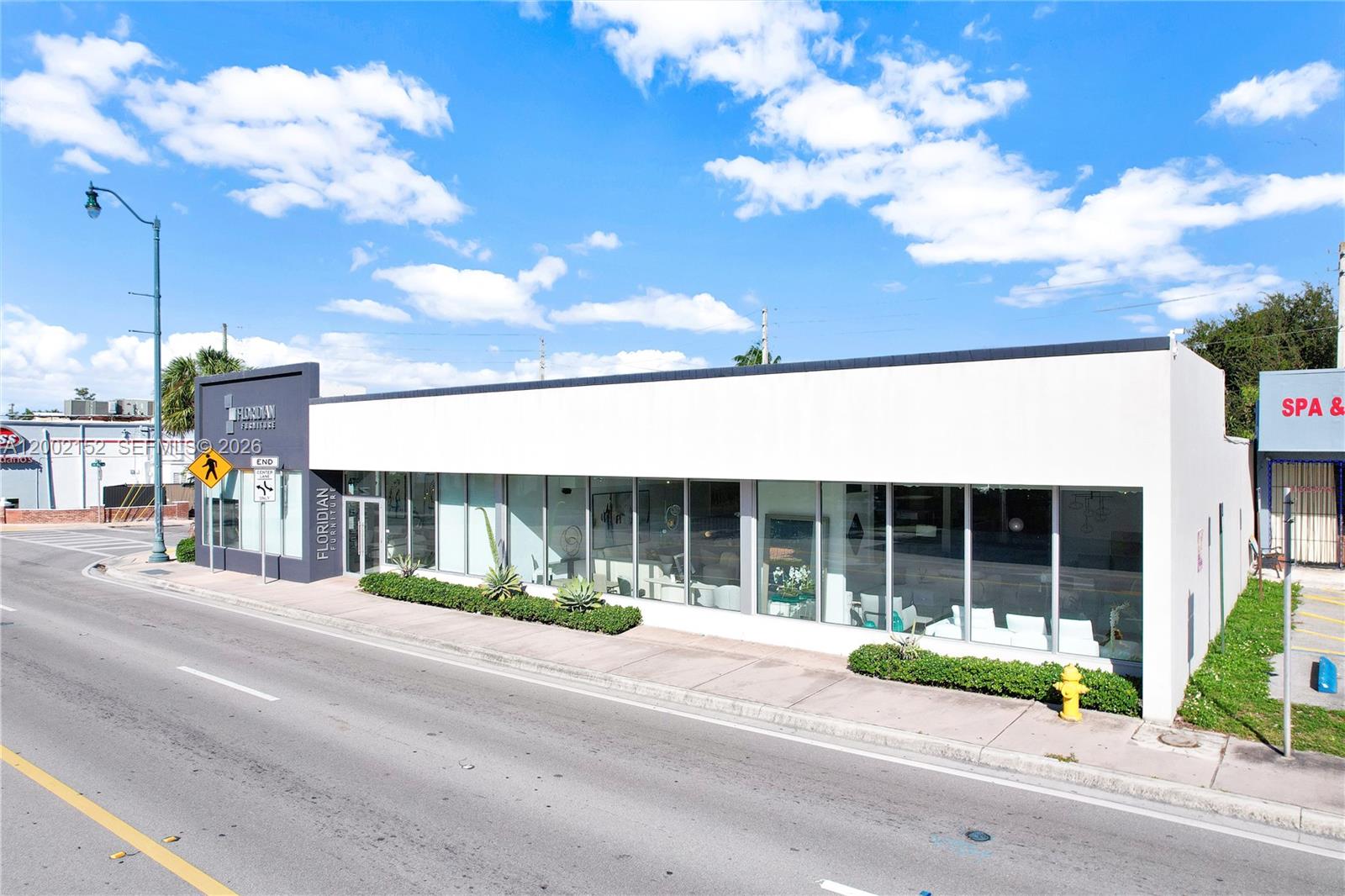 A modern, single-story commercial building with large glass windows and a white exterior facade — 4797 SW 8th St, Miami FL 33134, MIAMI, FL