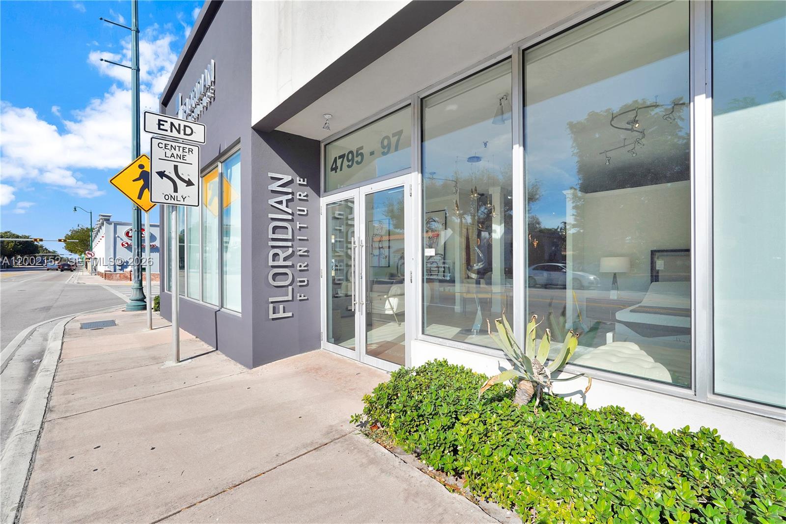 The exterior of a furniture store features large glass windows and a prominent corner entrance — 4797 SW 8th St, Miami FL 33134, MIAMI, FL
