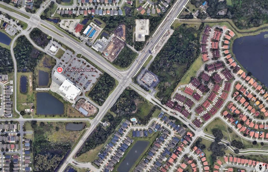 This is an aerial map view of a commercial building and surrounding residential neighborhoods — E OSCEOLA PARKWAY, KISSIMMEE, FL