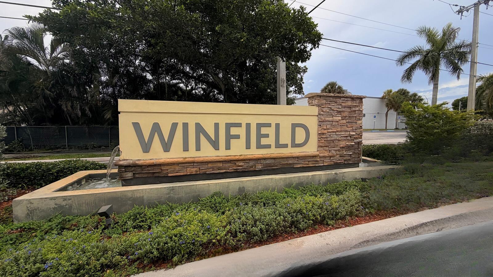 A stone and concrete monument sign for Winfield stands in front of lush landscaping — 2573 NW 58th Avenue, Margate FL 33063, MARGATE, FL