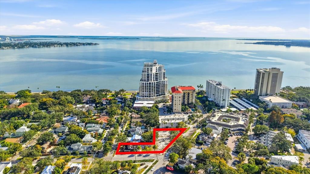 An aerial view shows a vacant lot outlined in red within a coastal residential neighborhood — 1401 S DESOTO AVENUE, TAMPA, FL