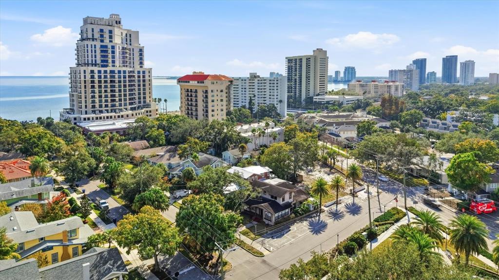 An aerial view shows a coastal city with high-rise buildings, residential houses, and palm trees — 1401 S DESOTO AVENUE, TAMPA, FL
