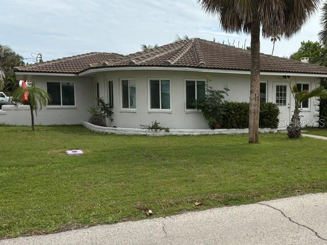 A single-story house with a tiled roof, white exterior, and a curved front wall — 56 LAUREL STREET, CLEARWATER BEACH, FL