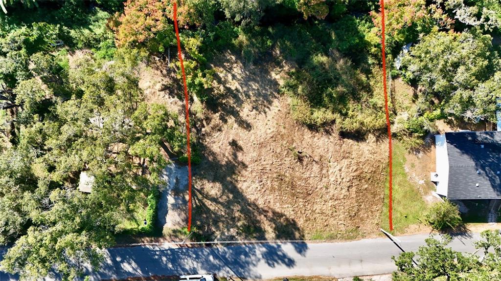 An aerial view shows a cleared, rectangular vacant lot bordered by trees and a road — 916 NASHVILLE ROAD, LAKELAND, FL