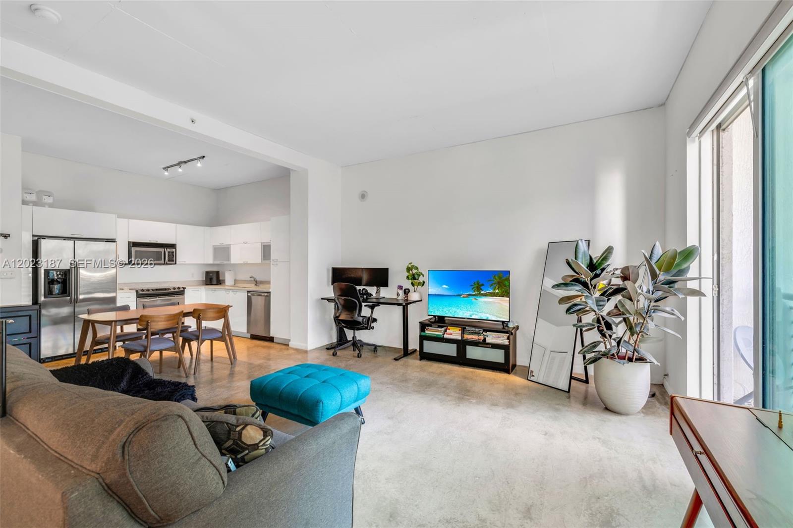 An open-concept living area features a kitchen, dining space, and office area with concrete floors — 234 NE 3rd St # 1108, Miami FL 33132, MIAMI, FL