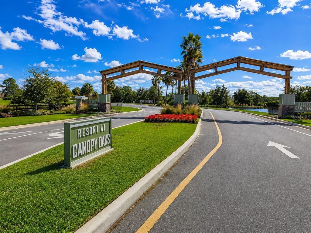 The entrance to a resort community features wooden archways over a paved road with signage — 0 CR-630 E Lot 108, LAKE WALES, FL