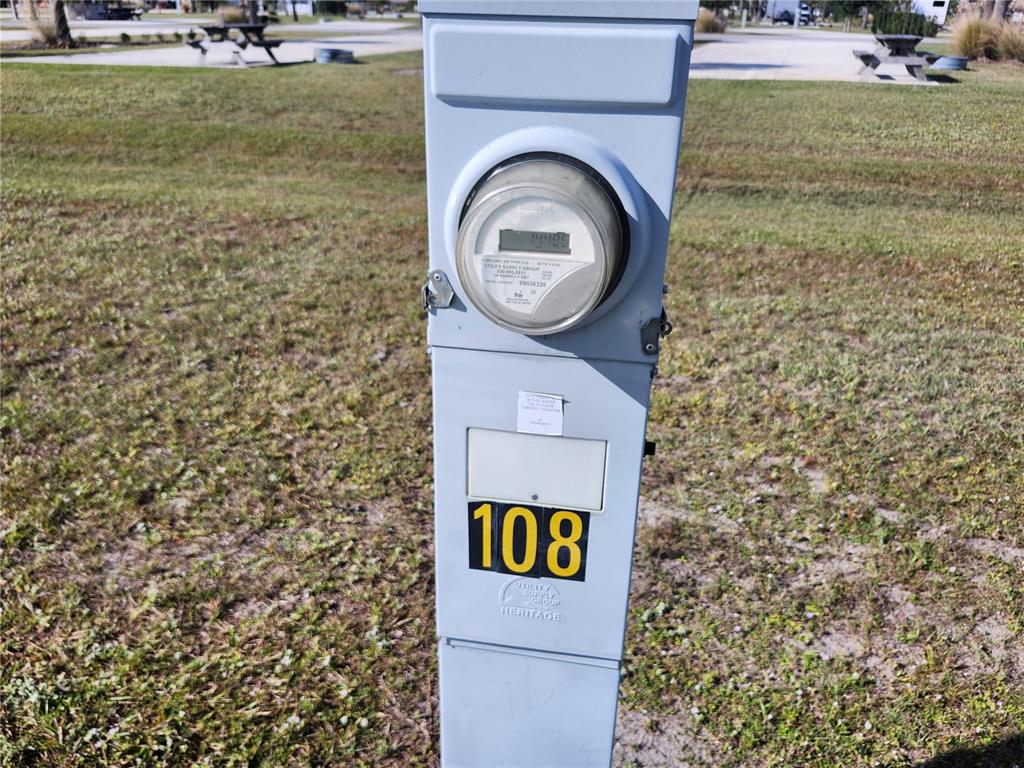 A gray utility pedestal with an electric meter and the number 108 stands outdoors — 0 CR-630 E Lot 108, LAKE WALES, FL