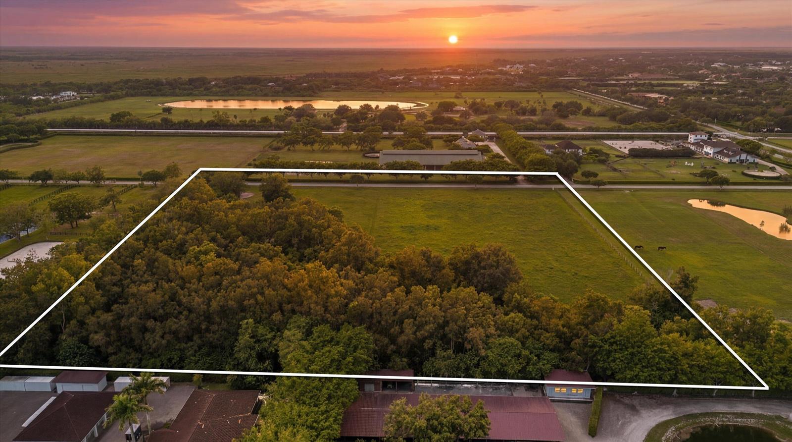 An aerial view shows a large, rectangular plot of land featuring trees and open grass — 5266 138th Terrace S, Wellington FL 33449, WELLINGTON, FL