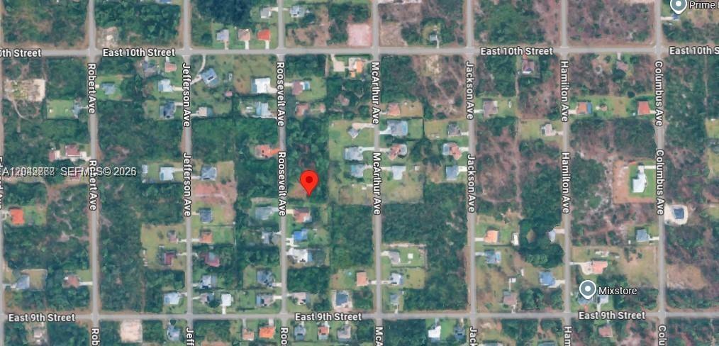 This is a satellite map view showing a vacant residential lot marked with a pin — 910 Roosevelt Ave, Lehigh Acres FL 33936, LEHIGH ACRES, FL