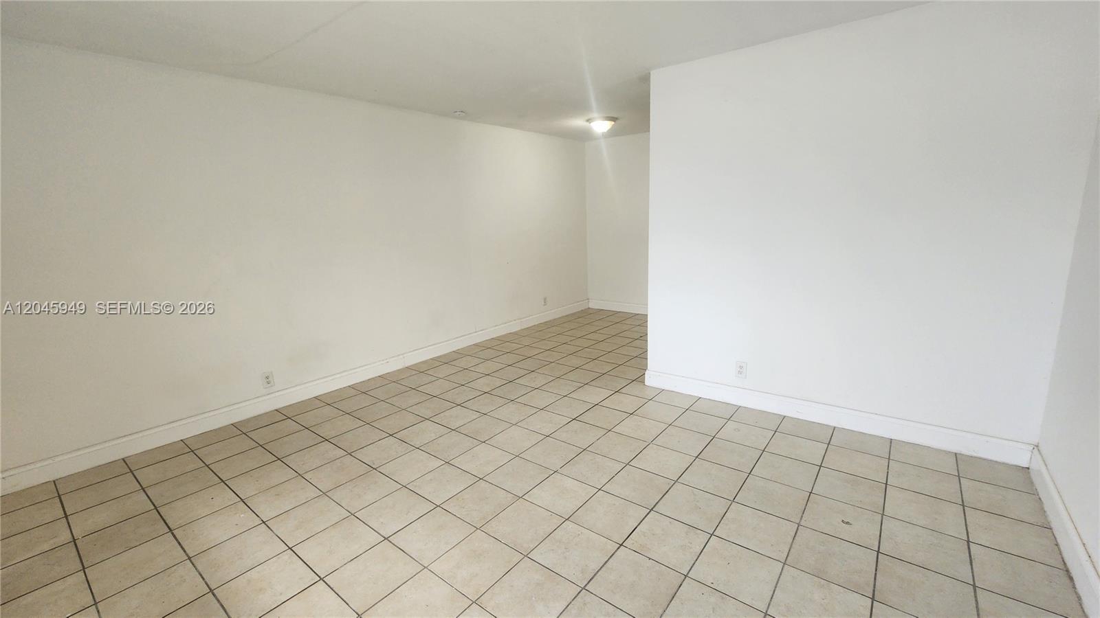 An empty room features white walls, a light-colored tiled floor, and a single ceiling light — 280 SW 11th Ave # 5, Hallandale Beach FL 33009, HALLANDALE BEACH, FL