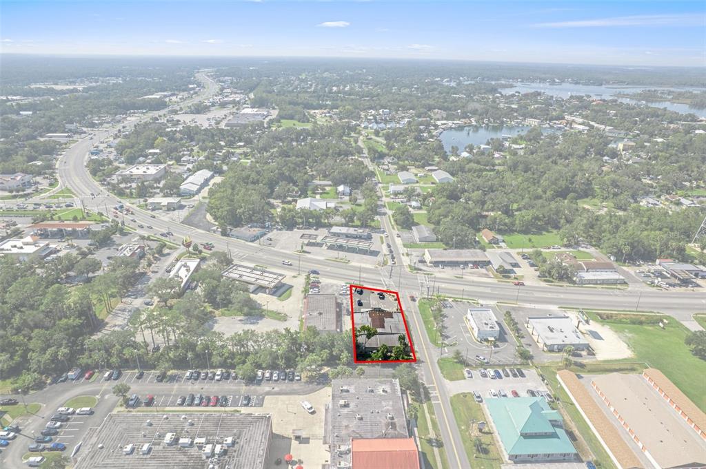 An aerial view shows a commercial property outlined in red along a busy road — 669 NE US HIGHWAY 19, CRYSTAL RIVER, FL