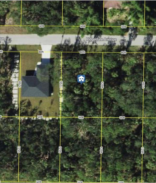 This is an aerial map showing a vacant residential lot next to an existing house — 19083 RIDGEDALE AVENUE, PORT CHARLOTTE, FL