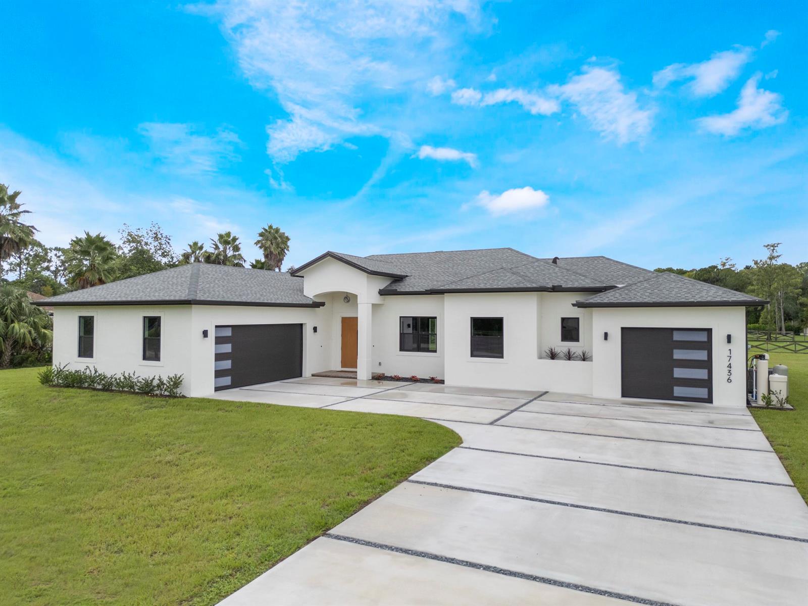 A backyard features a swimming pool with a safety fence and a paved patio area — 17436 71st Lane N, Loxahatchee FL 33470, LOXAHATCHEE, FL