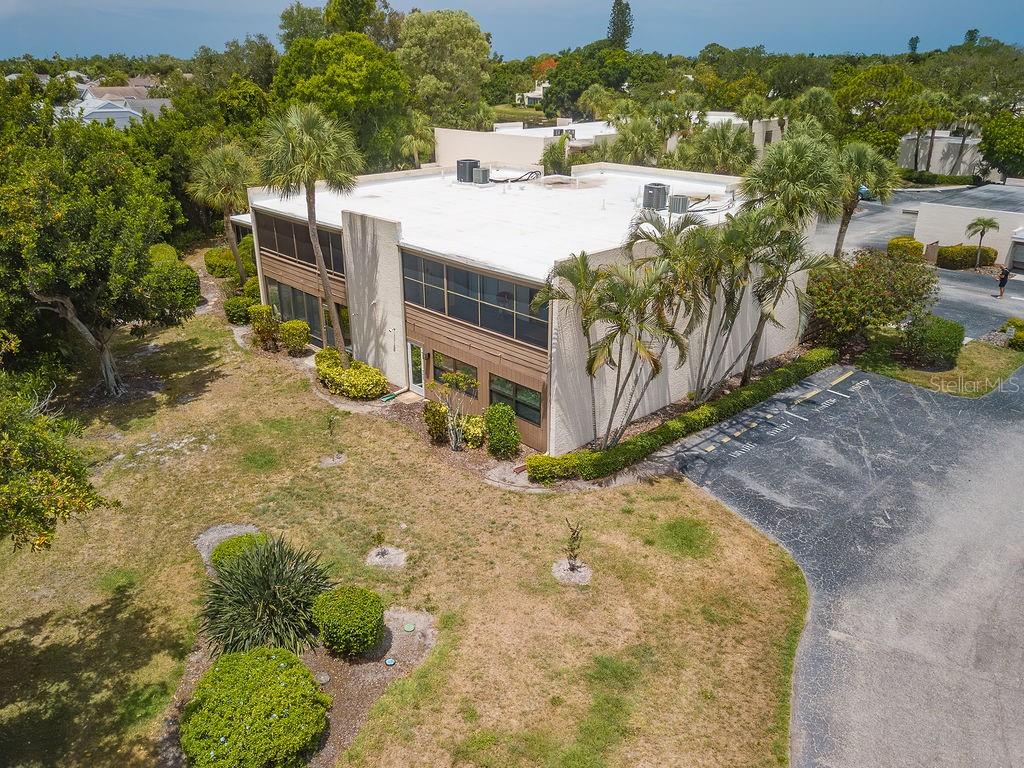 An aerial view of a two-story commercial building with a flat roof and palm trees — 193 PINENEEDLE DRIVE, BRADENTON, FL